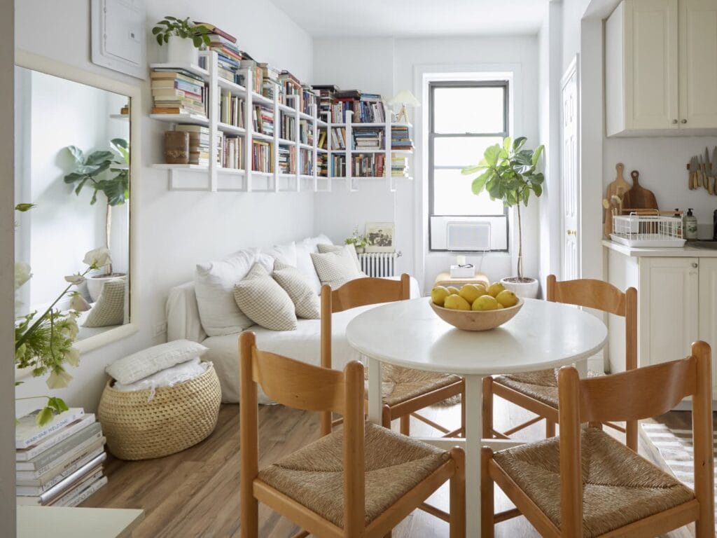 Organized small living space with shelves, multifunctional furniture, and minimalist décor for a stylish home